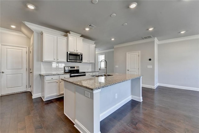 kitchen with an island with sink, visible vents, appliances with stainless steel finishes, and a sink