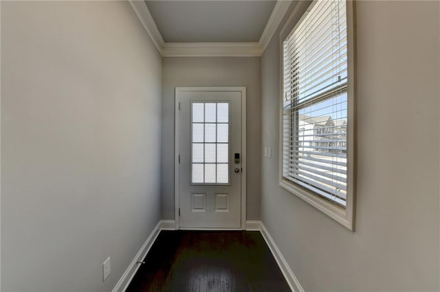 doorway to outside featuring dark wood-style floors, baseboards, and ornamental molding