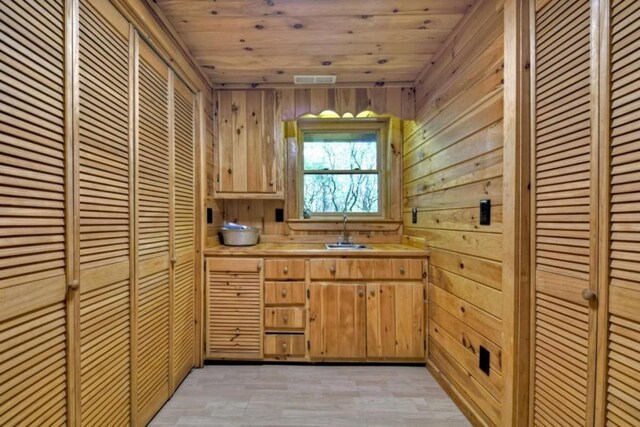 28452 Morganton Hwy, Suches, GA 30572 - kitchen featuring a sink, light countertops, wooden ceiling, and wood walls