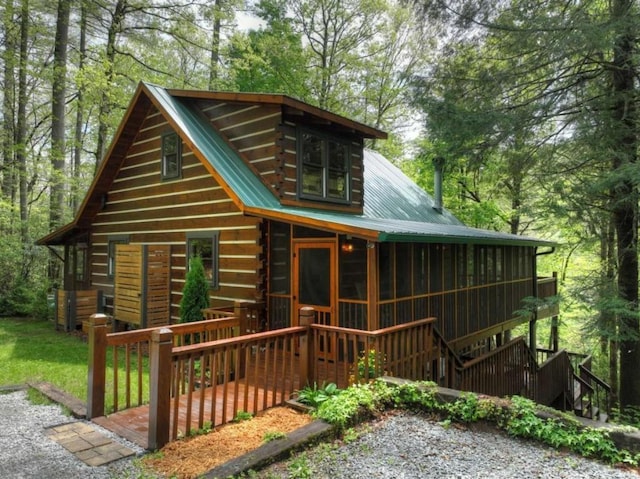 28452 Morganton Hwy, Suches, GA 30572 - view of front facade with metal roof, log exterior, a sunroom, and a deck