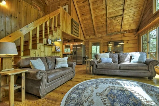 28452 Morganton Hwy, Suches, GA 30572 - living room with wood walls, wood ceiling with exposed beams, wood finished floors, and high vaulted ceiling