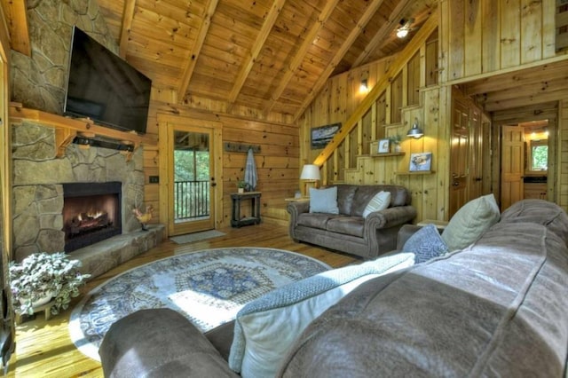 28452 Morganton Hwy, Suches, GA 30572 - living room with a fireplace, wooden walls, stairway, wood-type flooring, and wood ceiling with exposed beams