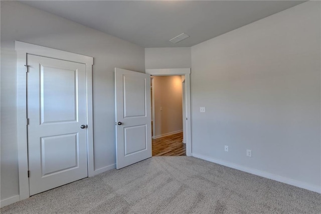 unfurnished bedroom featuring light colored carpet