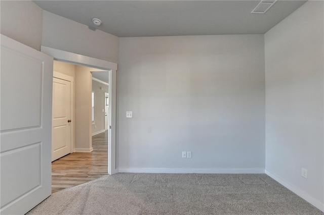 spare room featuring light hardwood / wood-style floors