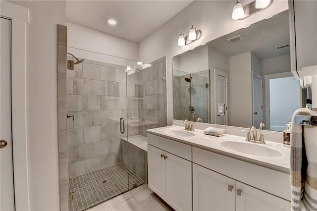 bathroom with tile patterned flooring, vanity, and walk in shower