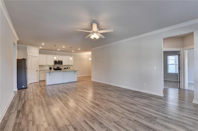 unfurnished living room with ceiling fan, light wood-type flooring, and crown molding