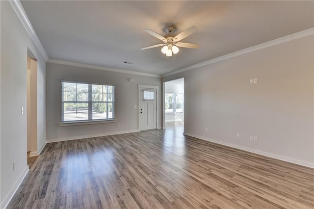 spare room with ceiling fan, wood-type flooring, and crown molding