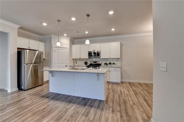 kitchen with white cabinets, an island with sink, and appliances with stainless steel finishes