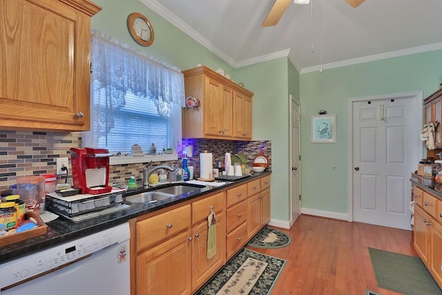 kitchen featuring backsplash, light wood-type flooring, ornamental molding, dishwasher, and sink