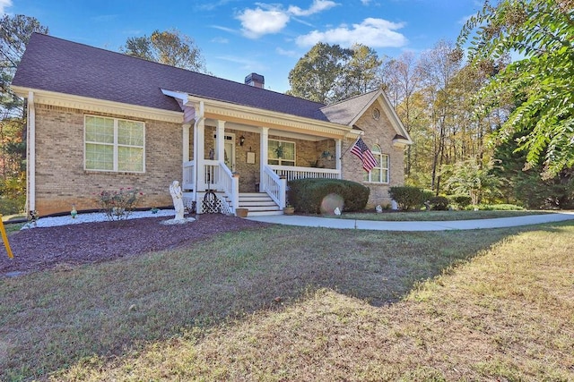 ranch-style house featuring a porch and a front yard