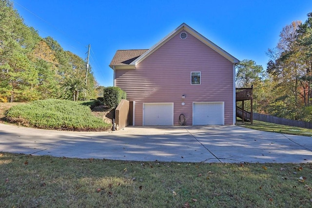 view of property exterior featuring a yard and a garage