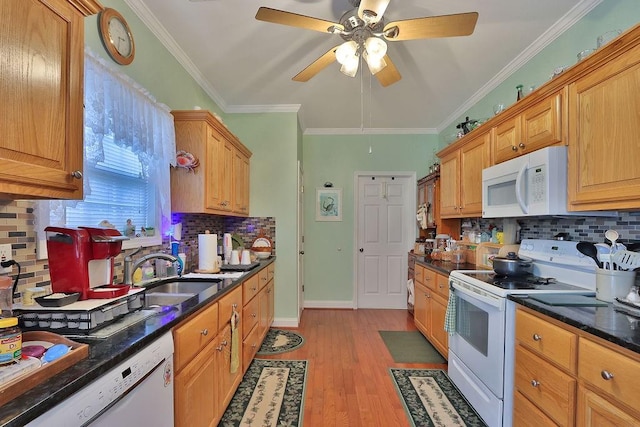 kitchen with light hardwood / wood-style flooring, sink, backsplash, and white appliances