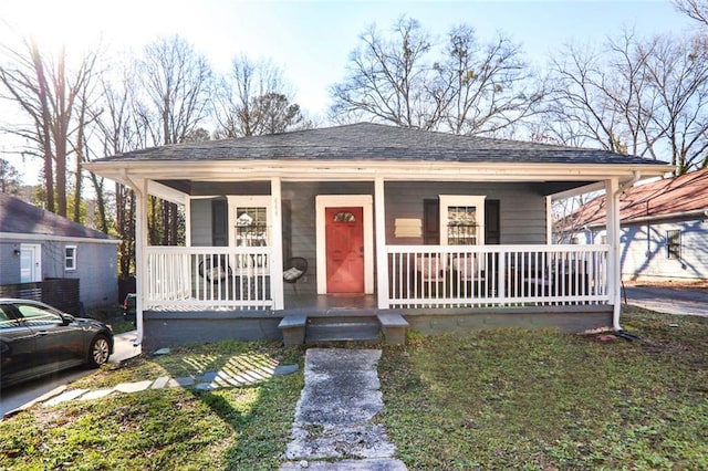 bungalow with a porch and roof with shingles