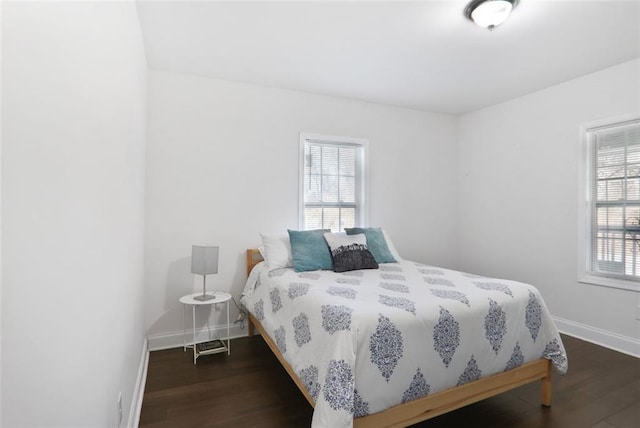 bedroom featuring wood finished floors and baseboards