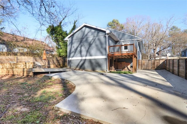 exterior space featuring a fenced backyard, a patio, and a wooden deck