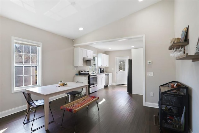 dining area with dark wood-type flooring, vaulted ceiling, and baseboards