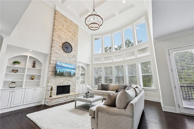 living room featuring a fireplace, dark hardwood / wood-style flooring, and a wealth of natural light