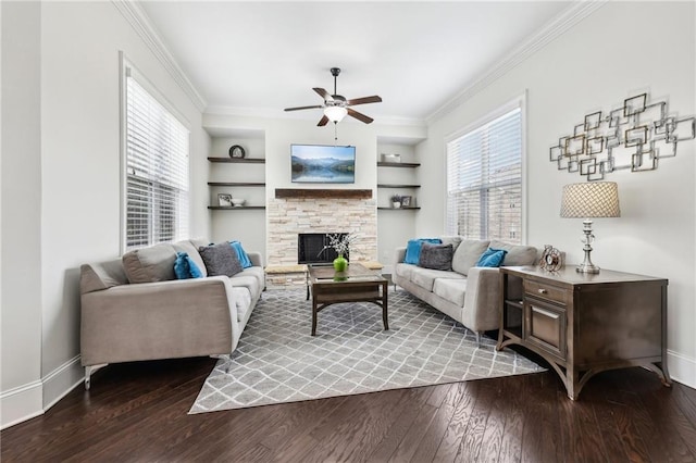 living room with hardwood / wood-style flooring, ornamental molding, a fireplace, and built in shelves