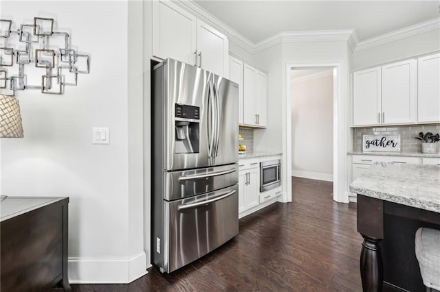 kitchen featuring white cabinetry, dark wood-type flooring, ornamental molding, and stainless steel appliances