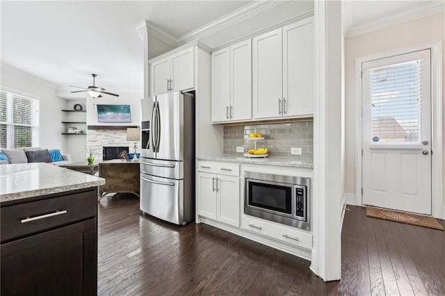 kitchen with white cabinetry, appliances with stainless steel finishes, and crown molding