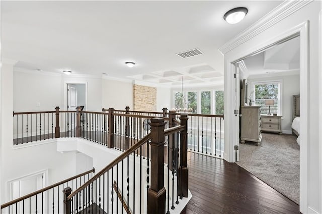 corridor featuring coffered ceiling, crown molding, and dark hardwood / wood-style floors