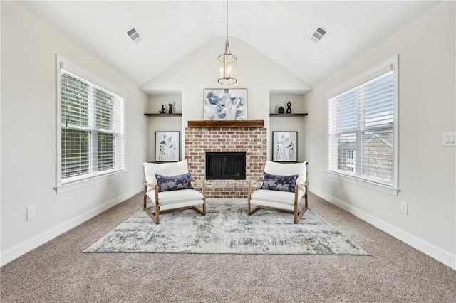 living area with carpet flooring, lofted ceiling, a healthy amount of sunlight, and built in shelves