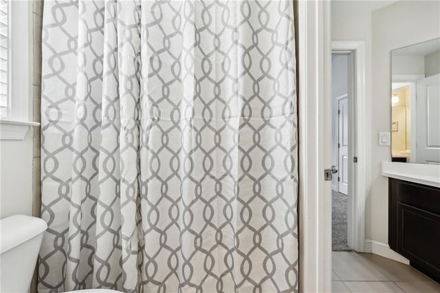 bathroom with tile patterned flooring, vanity, and toilet