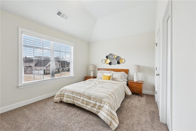 carpeted bedroom with lofted ceiling