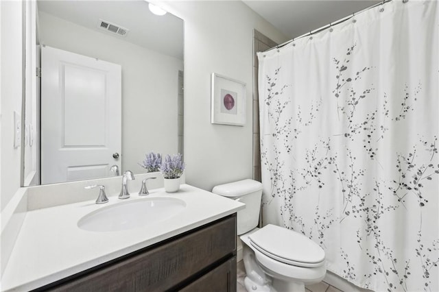 bathroom featuring vanity, walk in shower, and toilet