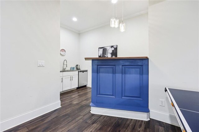 bar with sink, hanging light fixtures, white cabinets, dark hardwood / wood-style flooring, and stainless steel dishwasher