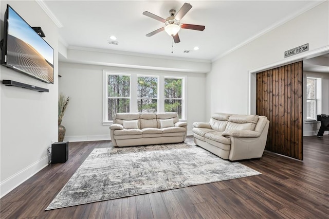 living room featuring crown molding, ceiling fan, and dark hardwood / wood-style floors