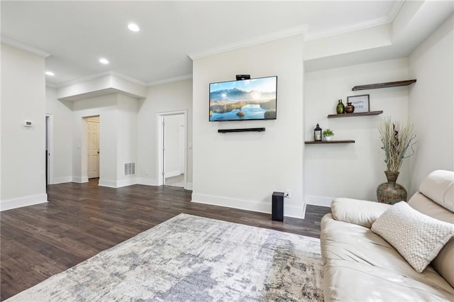 living room with ornamental molding and dark hardwood / wood-style floors