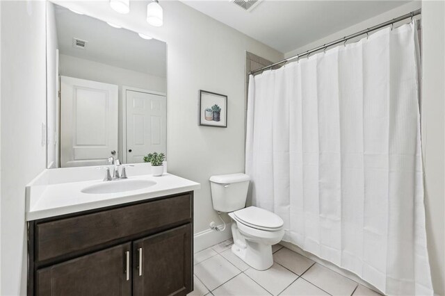 bathroom featuring a shower with curtain, vanity, tile patterned floors, and toilet