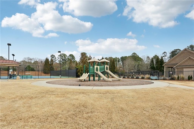 view of jungle gym with tennis court