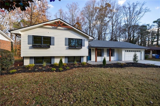 tri-level home with a garage and a front lawn