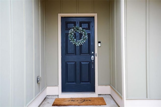 property entrance featuring board and batten siding