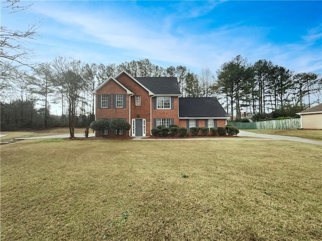 colonial home featuring a front lawn and brick siding