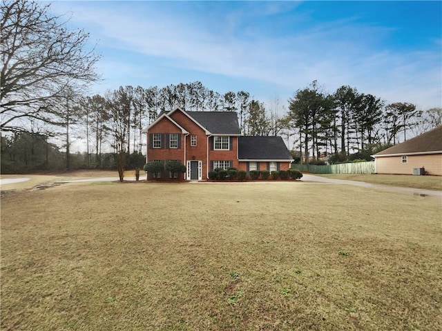 view of front of house with a front lawn and brick siding