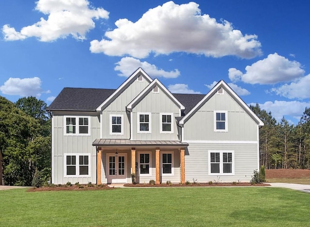 view of front of property featuring a porch, a standing seam roof, board and batten siding, and a front yard
