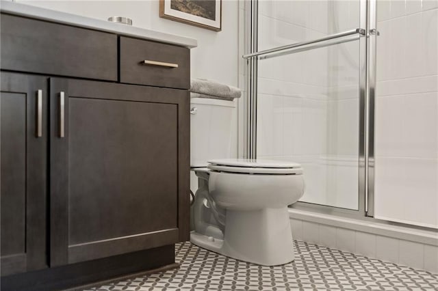 bathroom with toilet and a stall shower