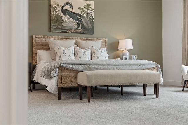 carpeted bedroom featuring baseboards