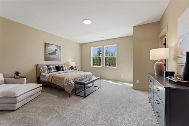 bedroom featuring baseboards and light carpet