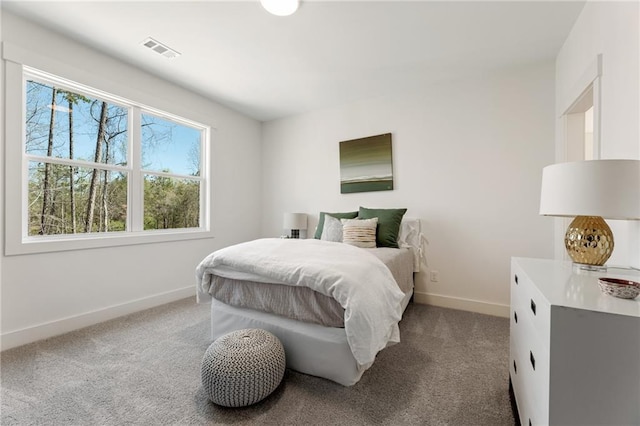 carpeted bedroom featuring baseboards and visible vents