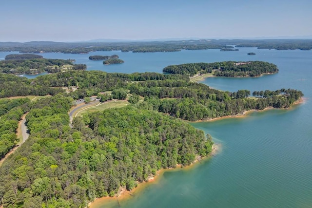 aerial view with a wooded view and a water view