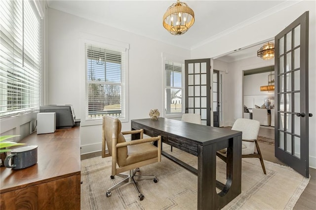 office featuring wood finished floors, an inviting chandelier, french doors, and plenty of natural light