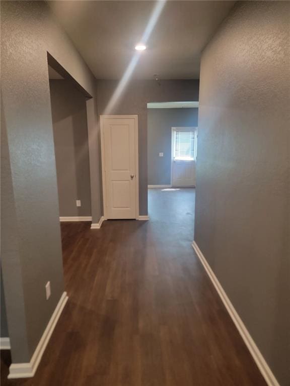 corridor featuring dark hardwood / wood-style flooring