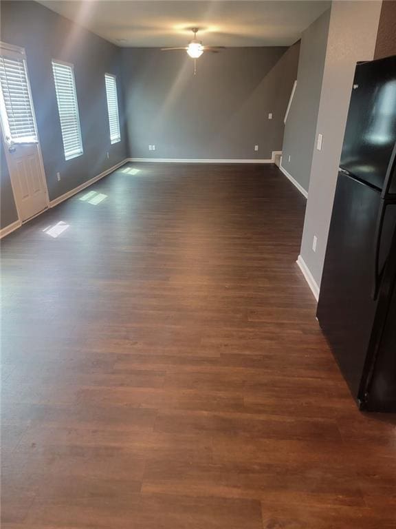 spare room featuring ceiling fan and dark wood-type flooring