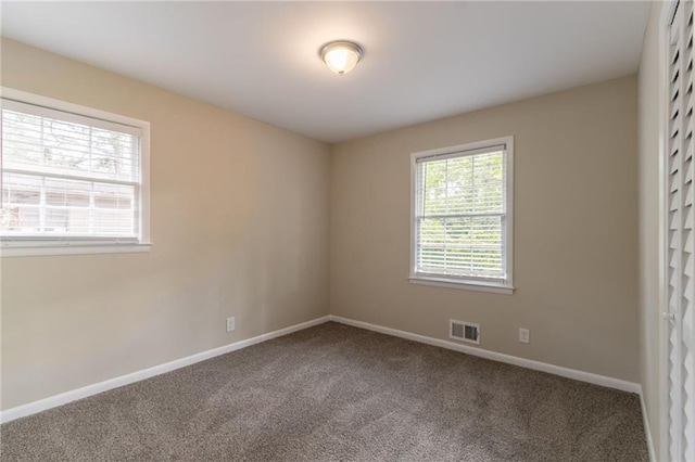 empty room with carpet and baseboards