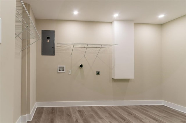 washroom featuring hookup for an electric dryer, washer hookup, electric panel, wood finished floors, and recessed lighting