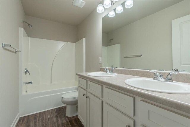 392 Dublin Way, Dallas, GA 30132 - full bathroom with bathing tub / shower combination, toilet, wood finished floors, and a sink